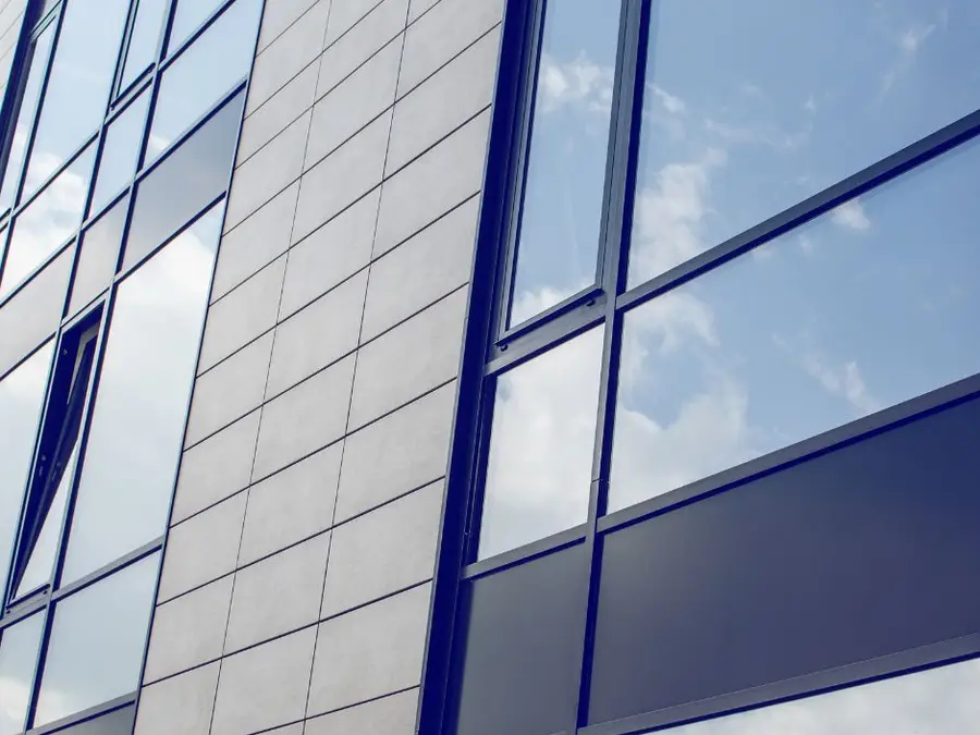 Blue reflective window film on a commercial office building facade